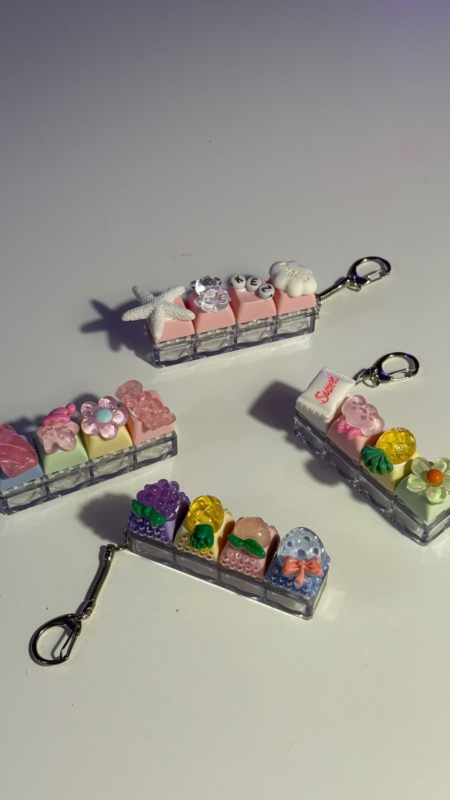Lollipop-style charm keychains laid out on a white table